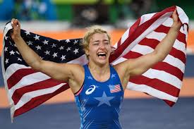 Helen Maroulis Cheering and holding a USA Flag over her shoulders