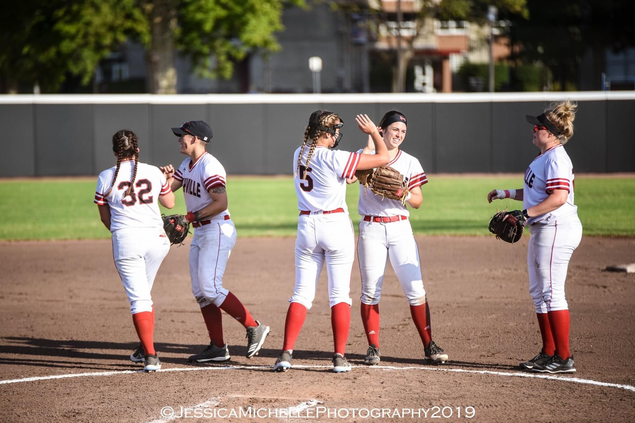 Softball players high fiving